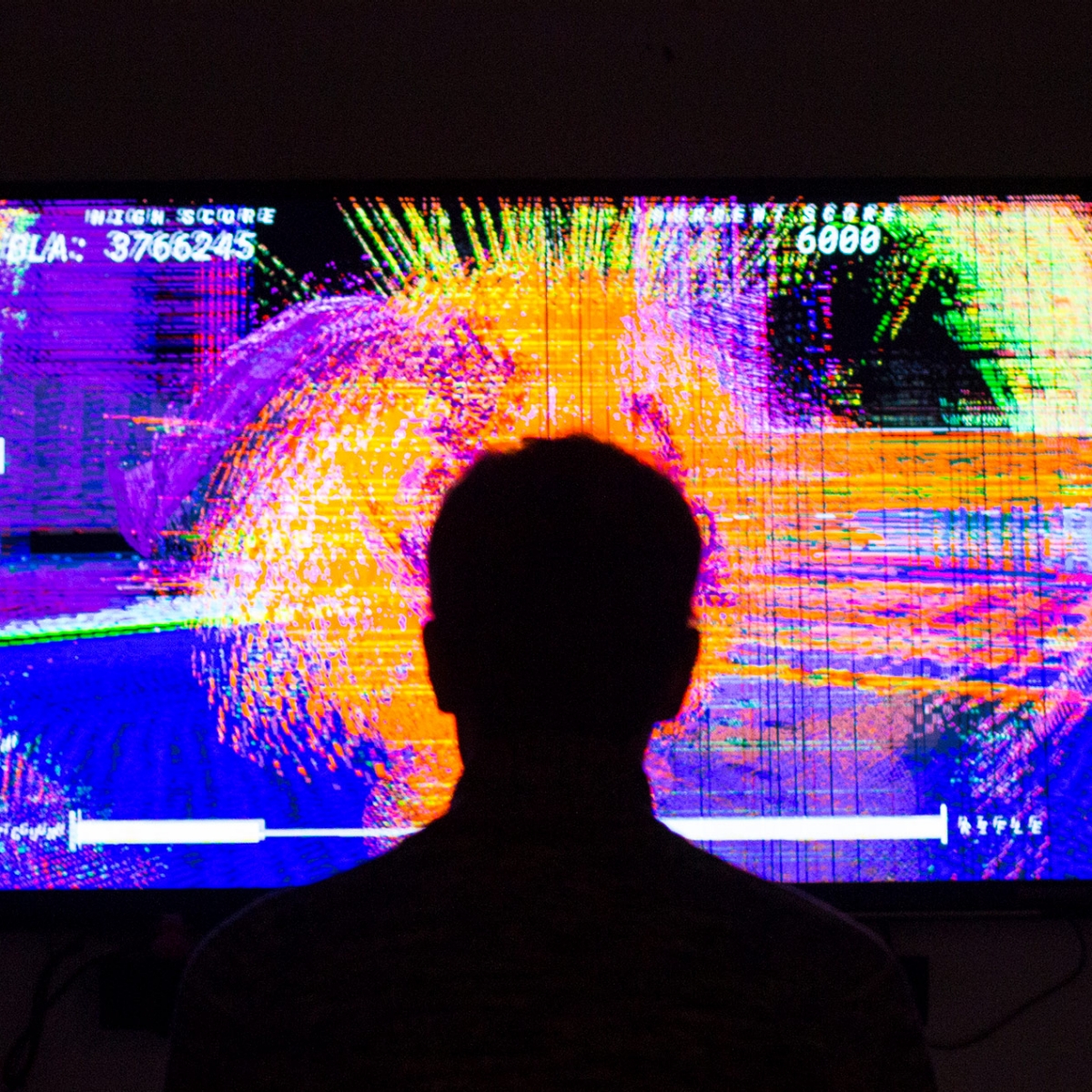 Player stands in front of glitch art game.