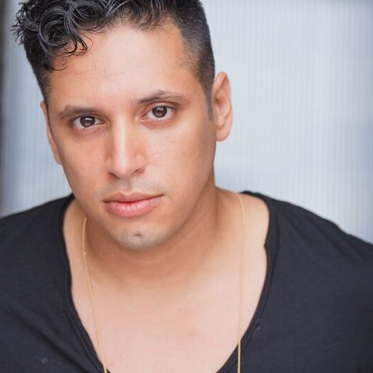 Ricardo Gamboa headshot Latino person with dark hair and black shirt