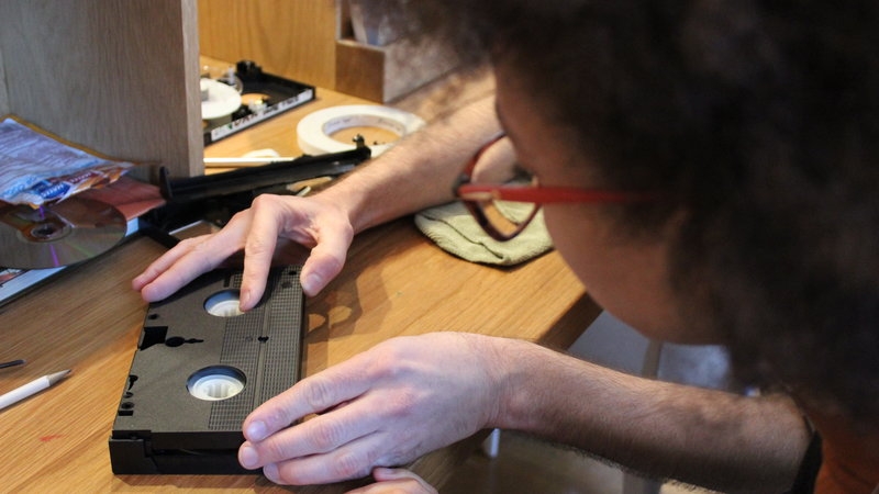 XFR Collective member Carmel Curtis (MIAP '15) working on a VHS tape. Photo credit: Lorena Ramirez-Lopez/XFR Collective.