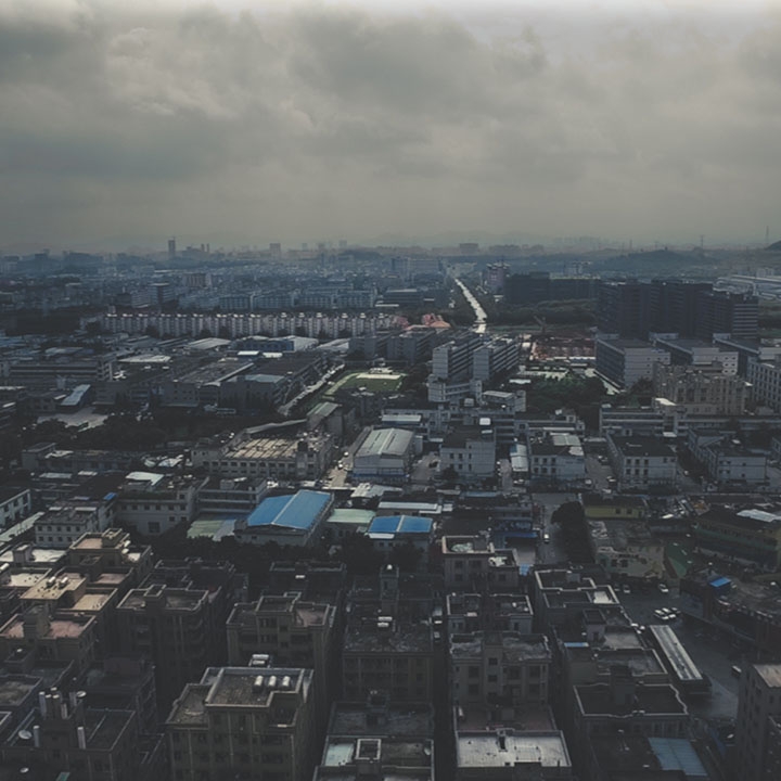 Screen capture from the film We the Workers: An aerial photo of a city.