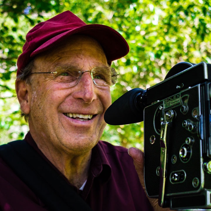 photo of Nathaniel Dorsky, with a film camera