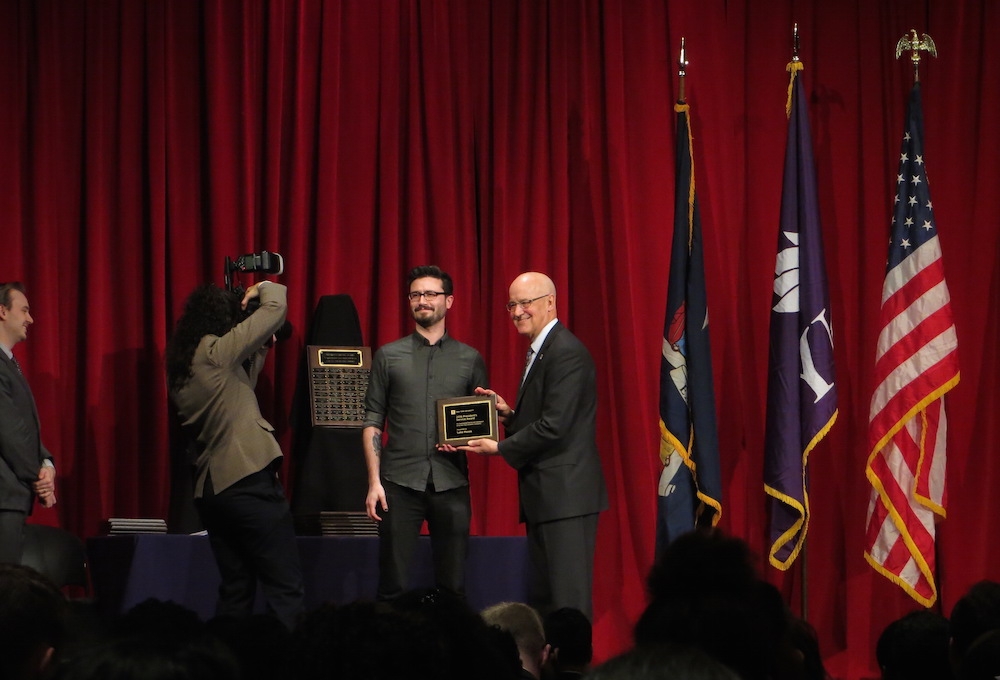 Luke Moses receives his President's Service Award from NYU President Andrew Hamilton in a ceremony held on April 14, 2016.