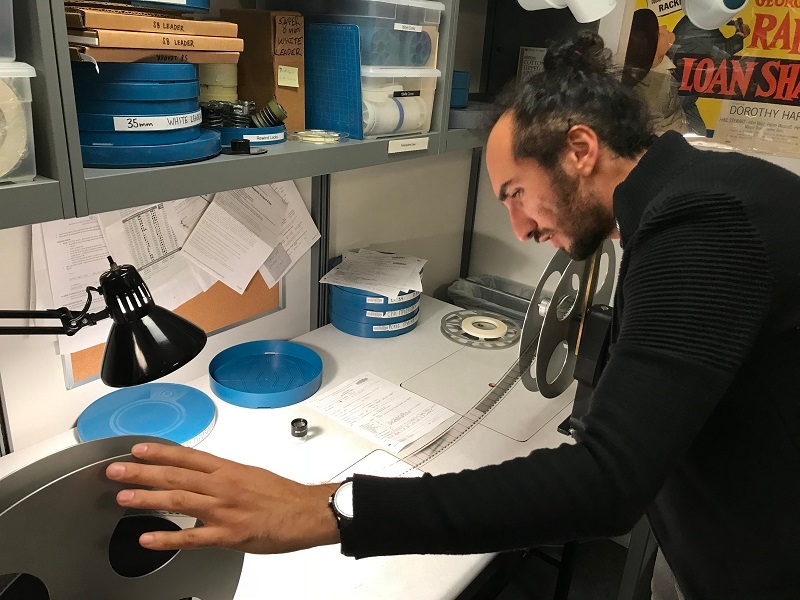 NYU MIAP student Shahed Dowlatshahi--winner of the Film Noir Foundation's 2018 Nancy Mysel Legacy Grant--inspecting film at NYU Libraries'  Barbara Goldsmith Preservation & Conservation Department. Photo credit: Michael Henry Grant (MIAP '15).