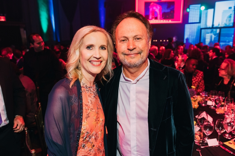 Dean Allyson Green in a pink floral dress and Billy Crystal in a blue blazer at the 2018 Tisch Gala