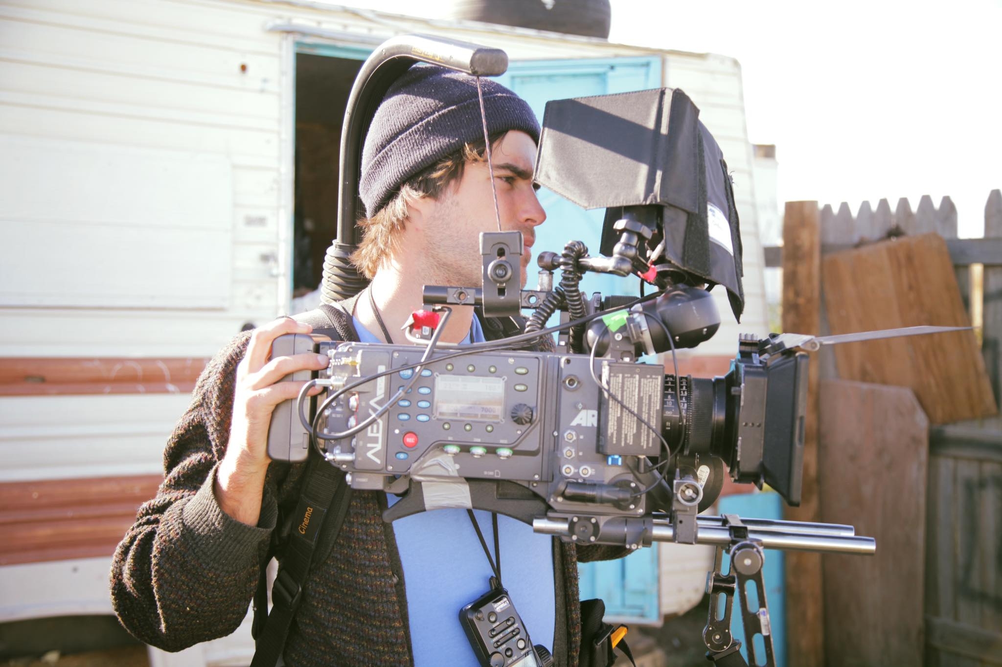 An image of a young man handling a camera rig.