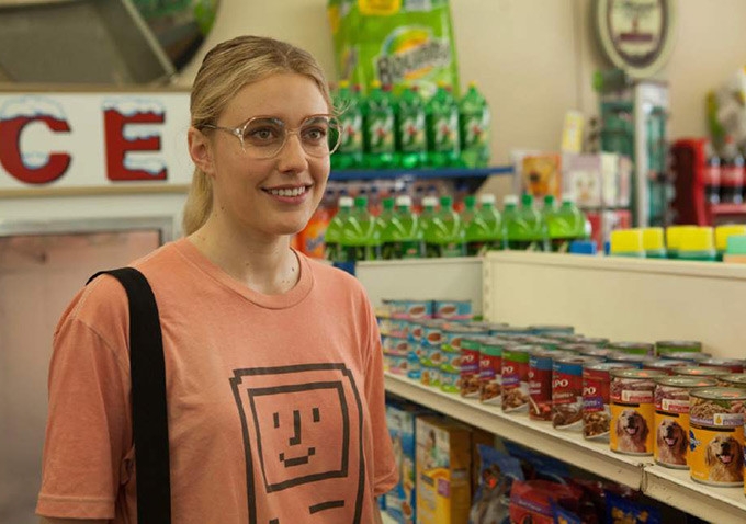 A film still of Wiener-Dog. Shown is a young woman in a grocery store.