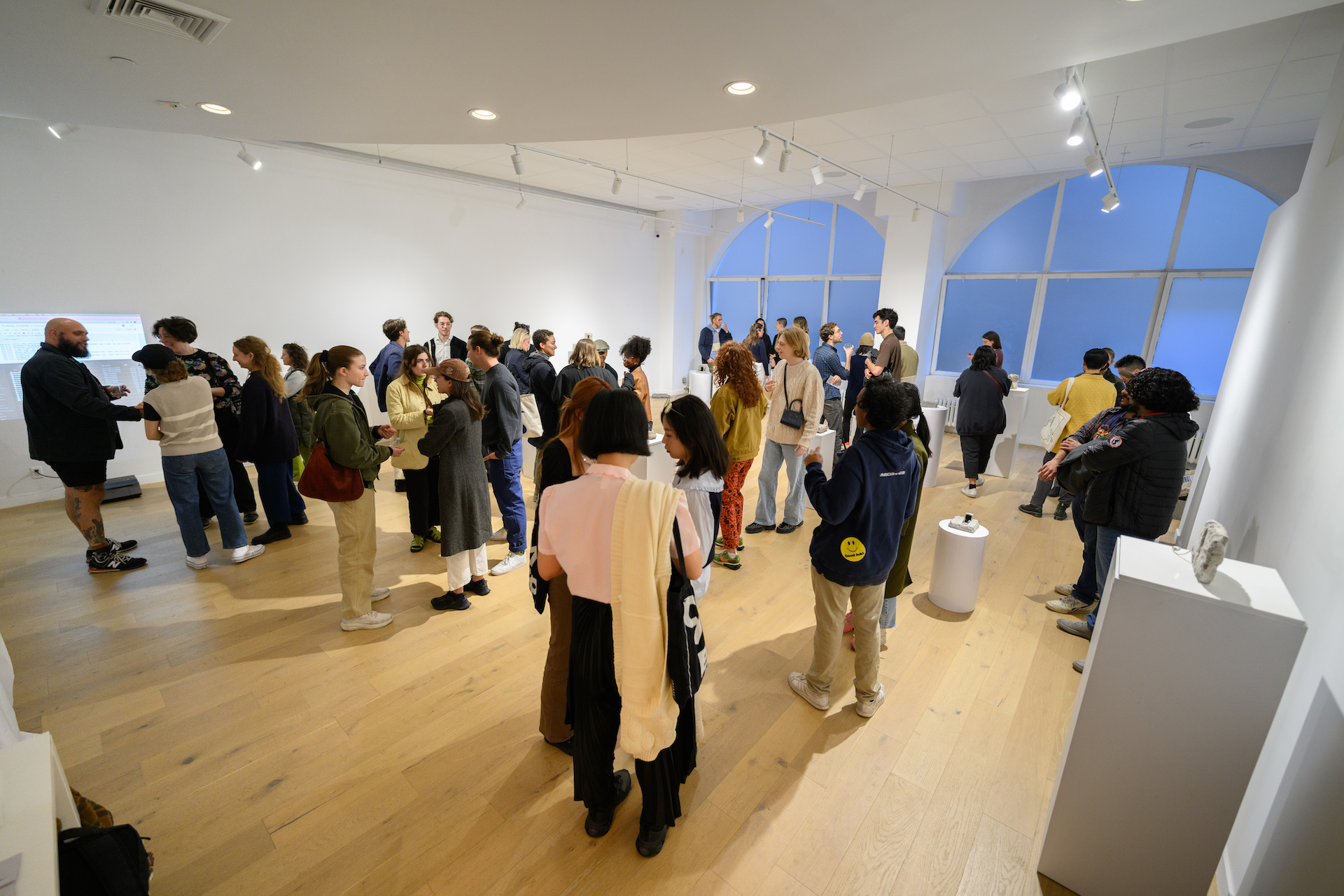 A room full of people visiting the exhibition