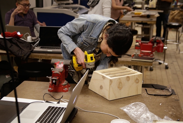 A woman with power tools working on her project.
