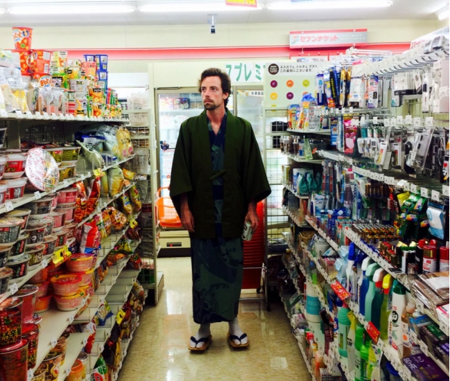 a man wearing a kimono in a grocery store aisle