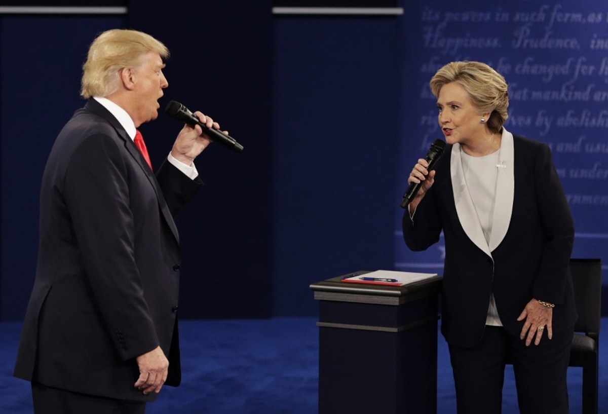 Donald Trump and Hillary Clinton holding microphones in a face off on stage