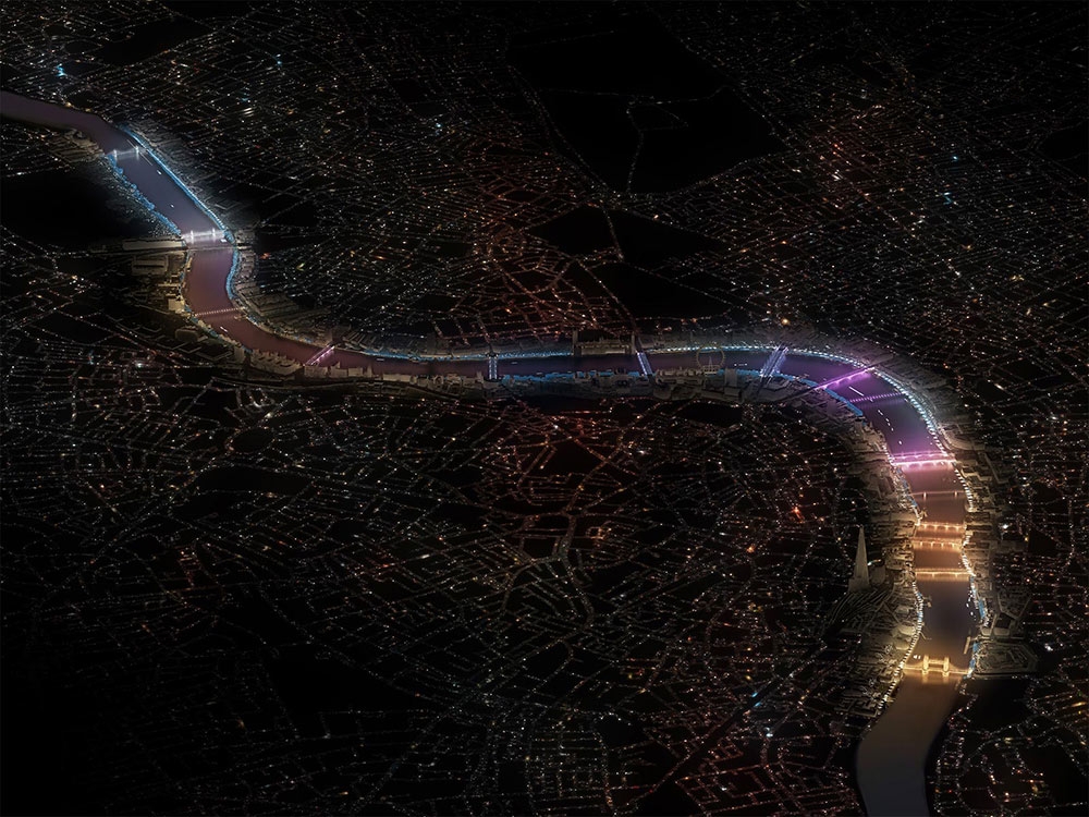 A satellite image of London at night with all 17 bridges along the Thames river lit up in bright colors