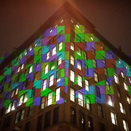 A building with colors projected onto the windows