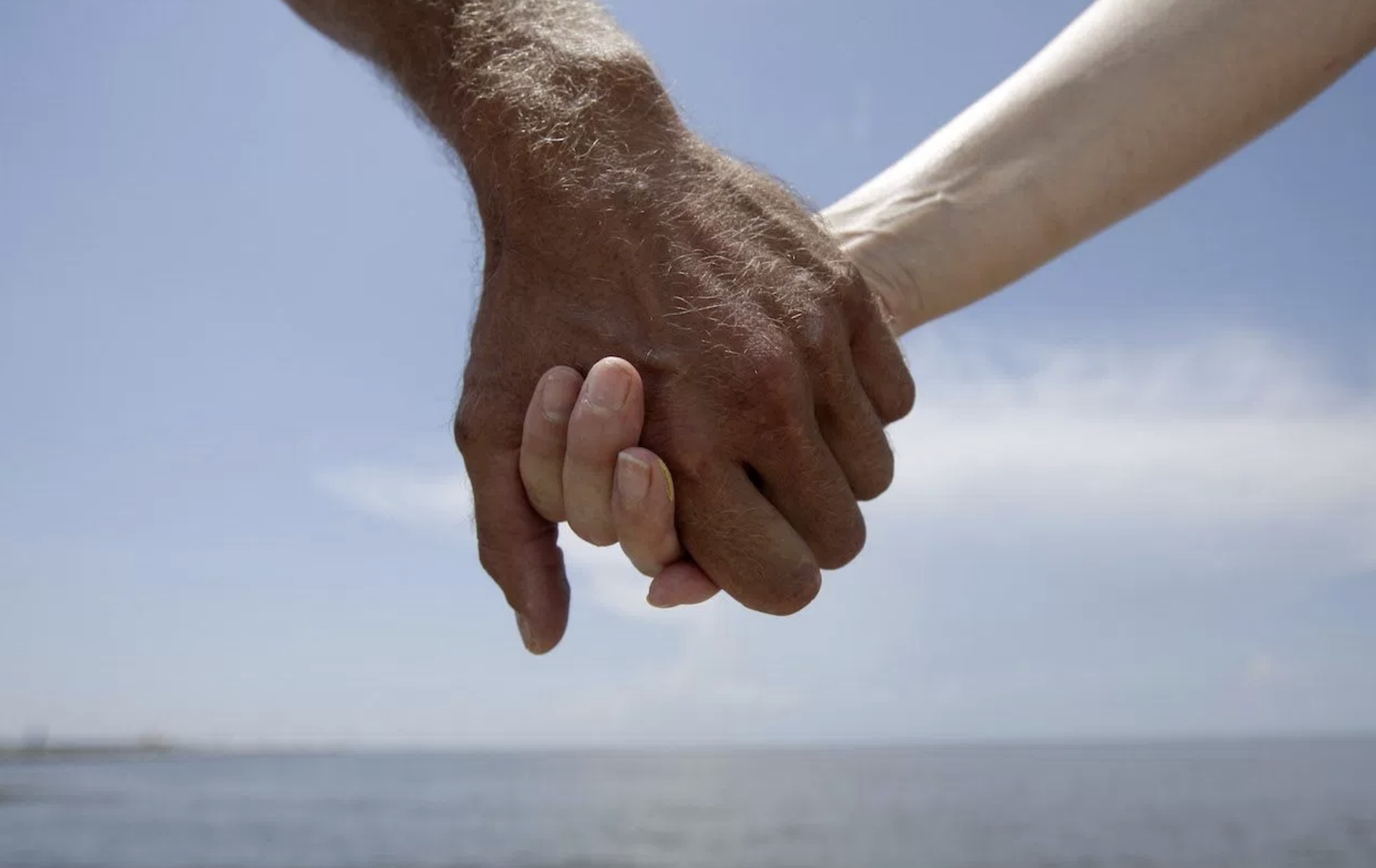 Hand holding, (AP Photo/Gregory Bull)