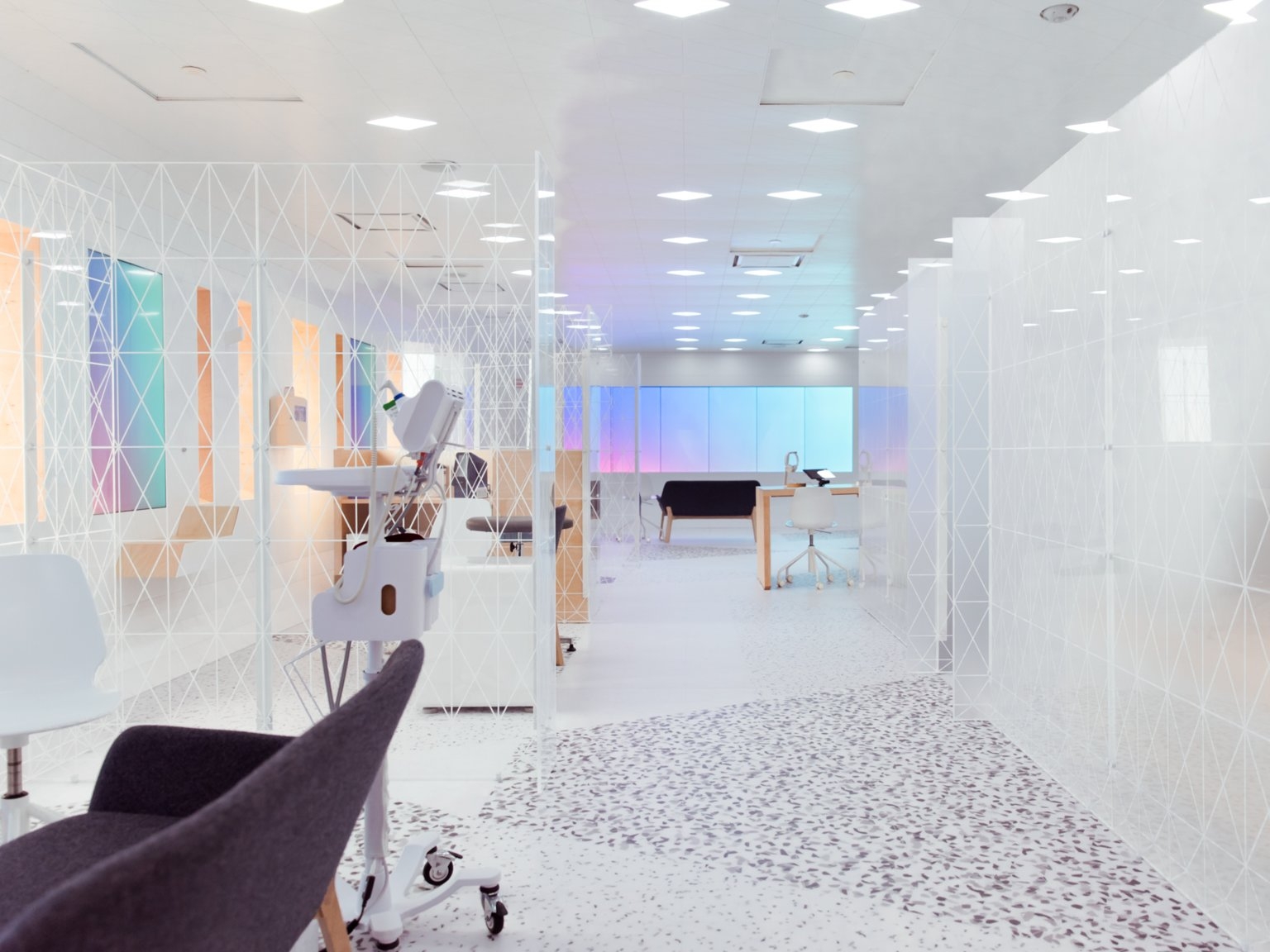 Image of a futuristic-looking lab with white walls and colored screens