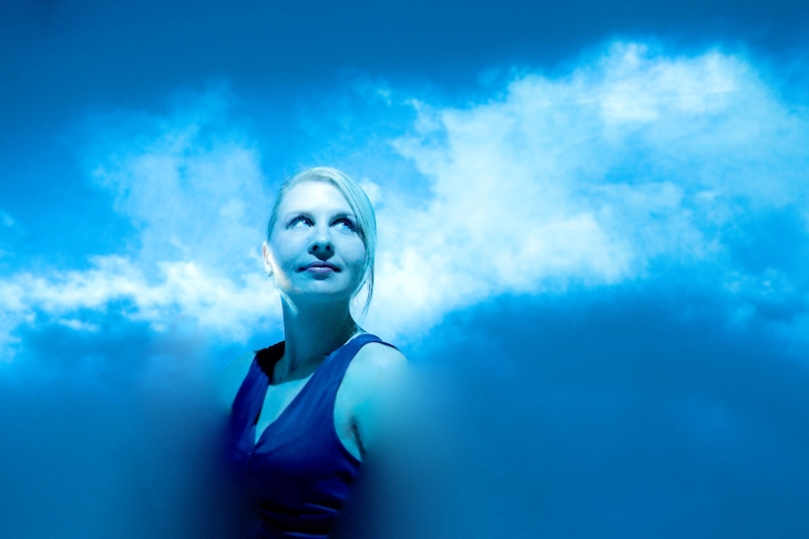 Maja Petric in a blue room, surrounded by what looks like clouds