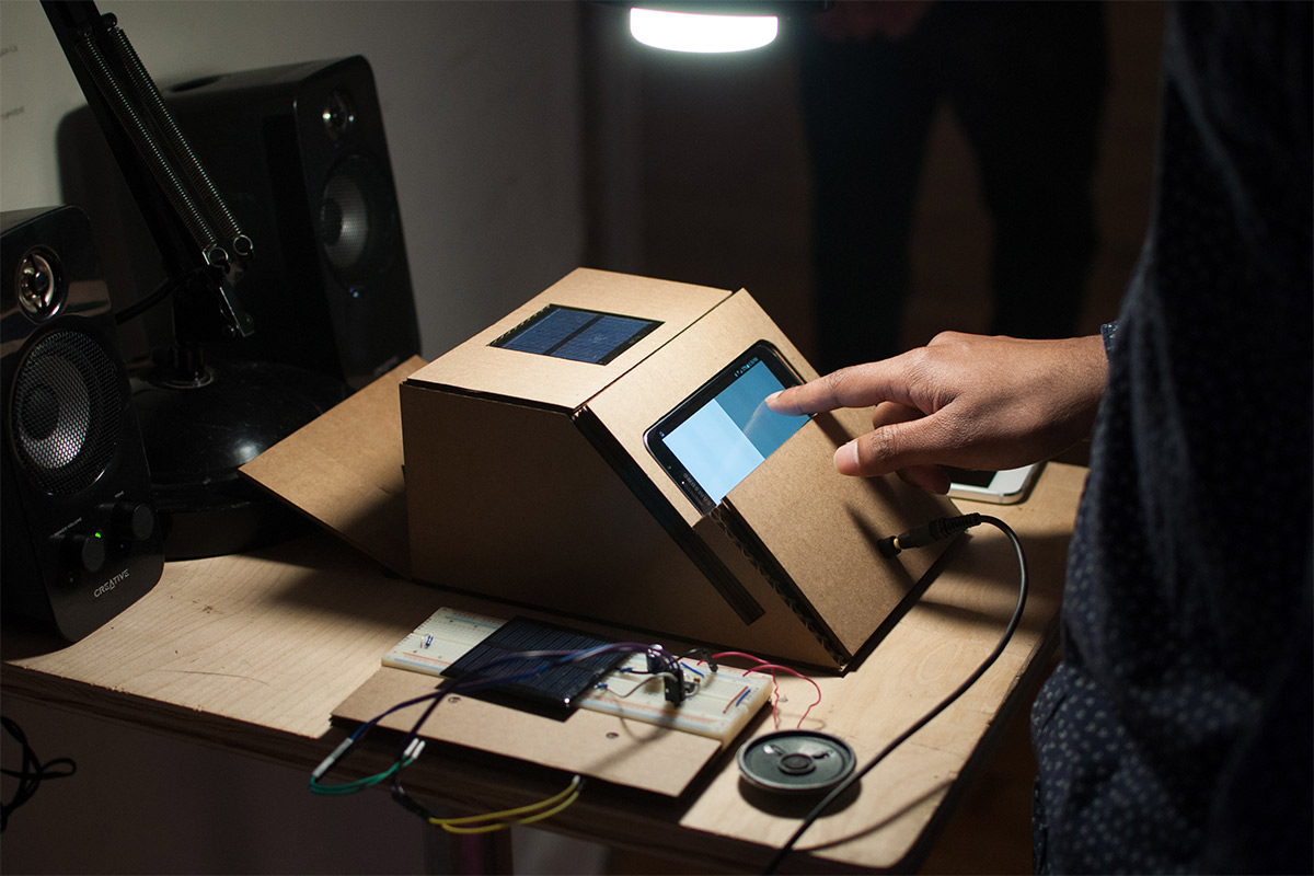 a cardboard box housing an iphone as the interface