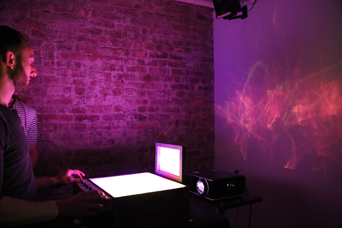 a person interacting with a screen projecting an ethereal shape on the screen