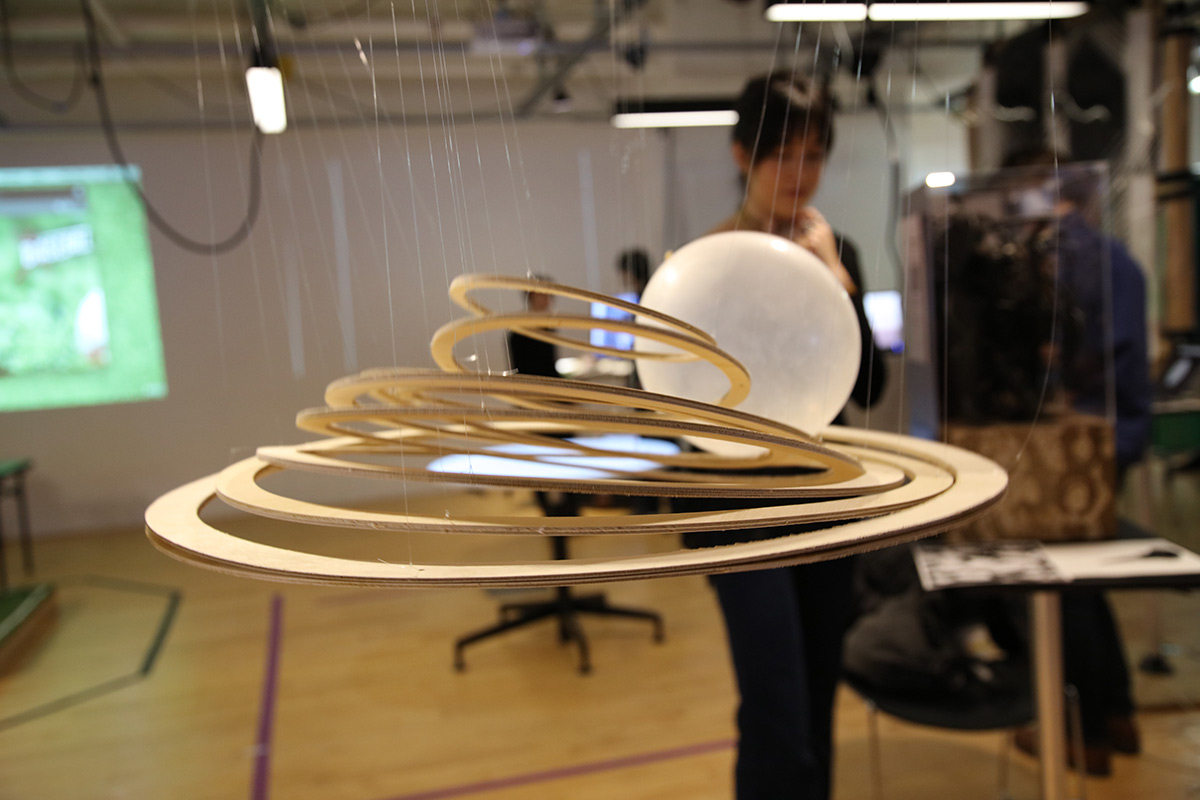 Wooden concentric circles suspended in air with a ball rolling on top