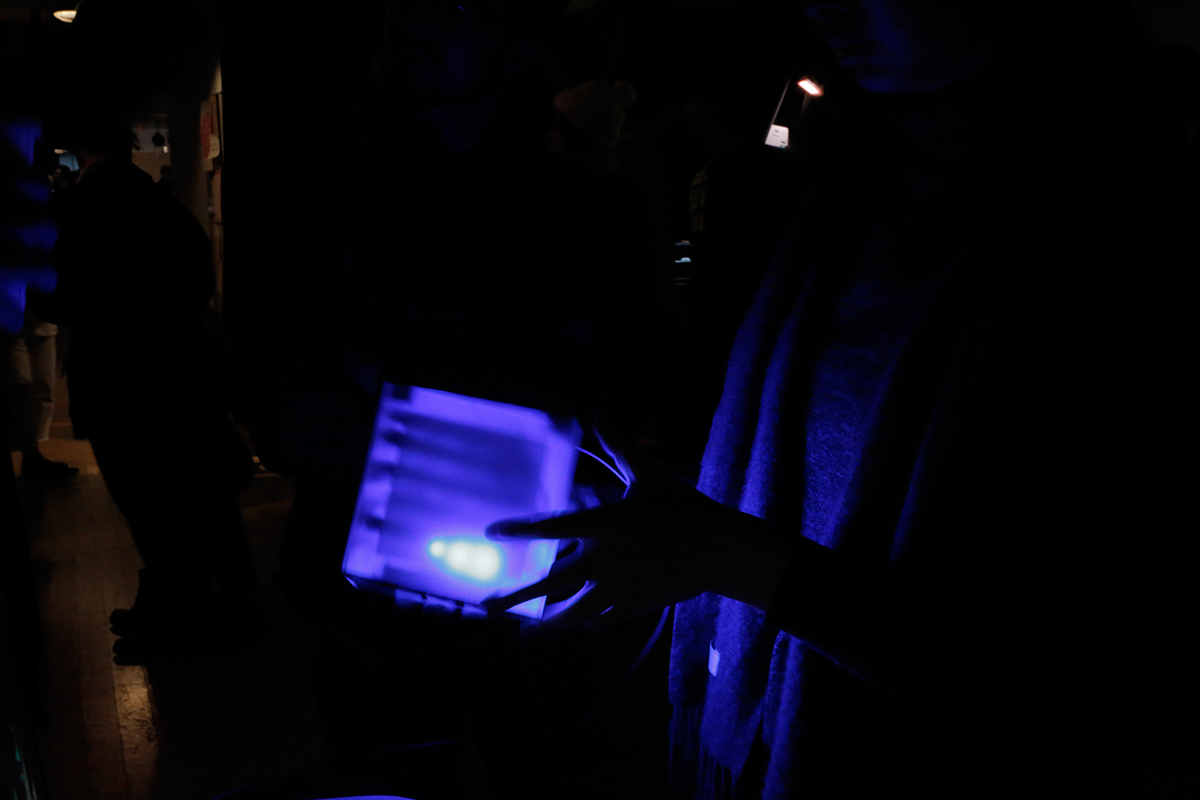 someone holding a lit up cube in the dark
