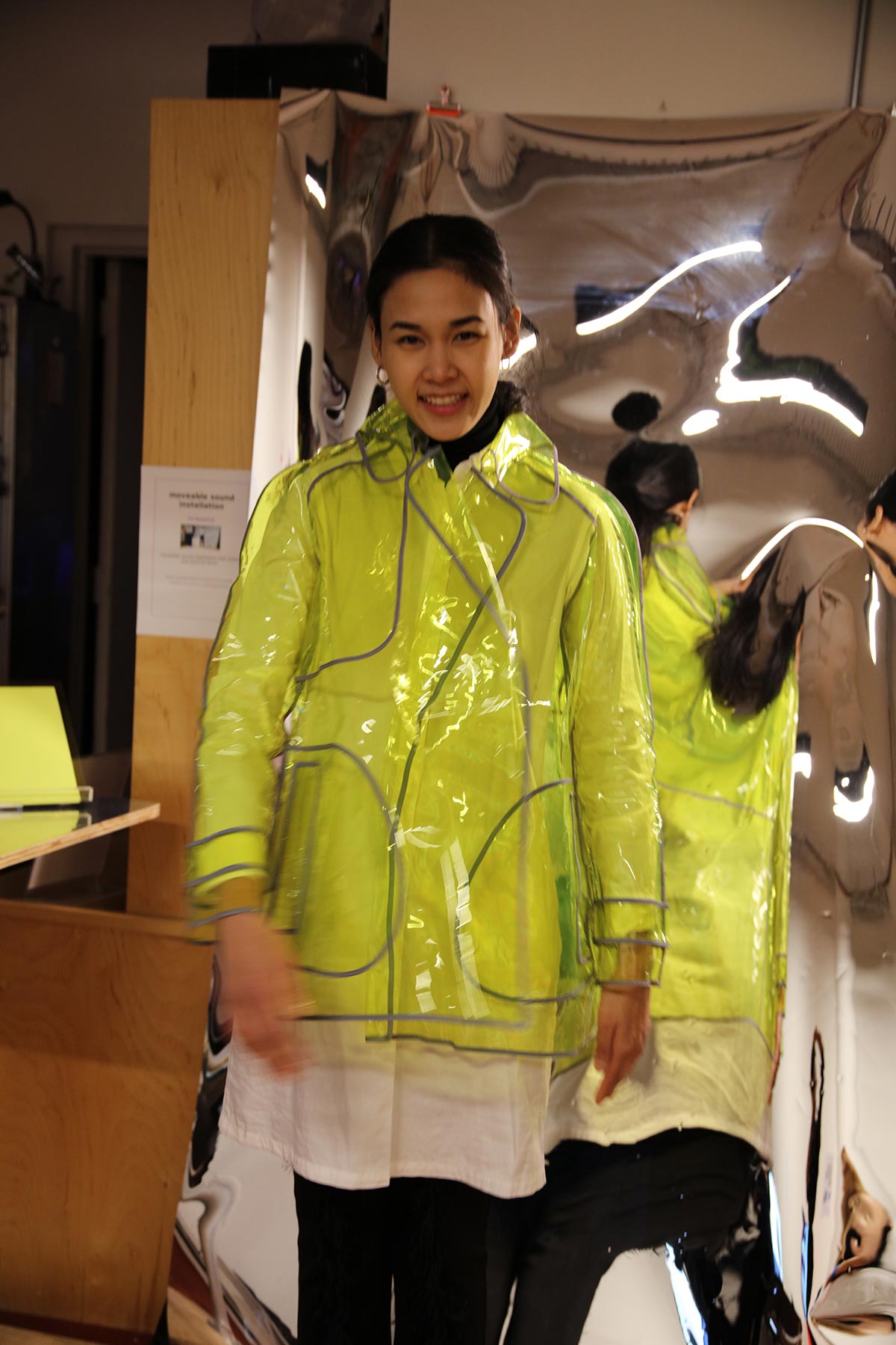 a woman wearing a fluorescent plastic raincoat