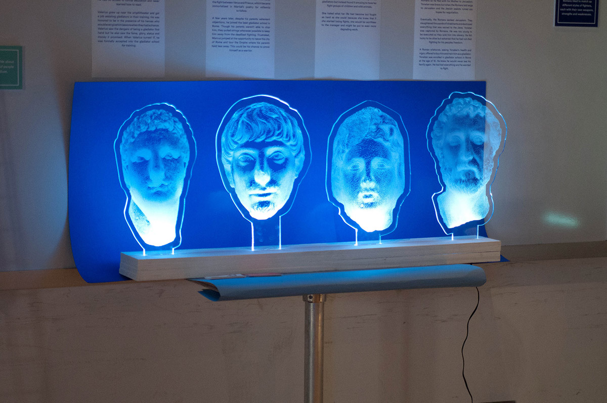 ancient faces projected onto acrylic