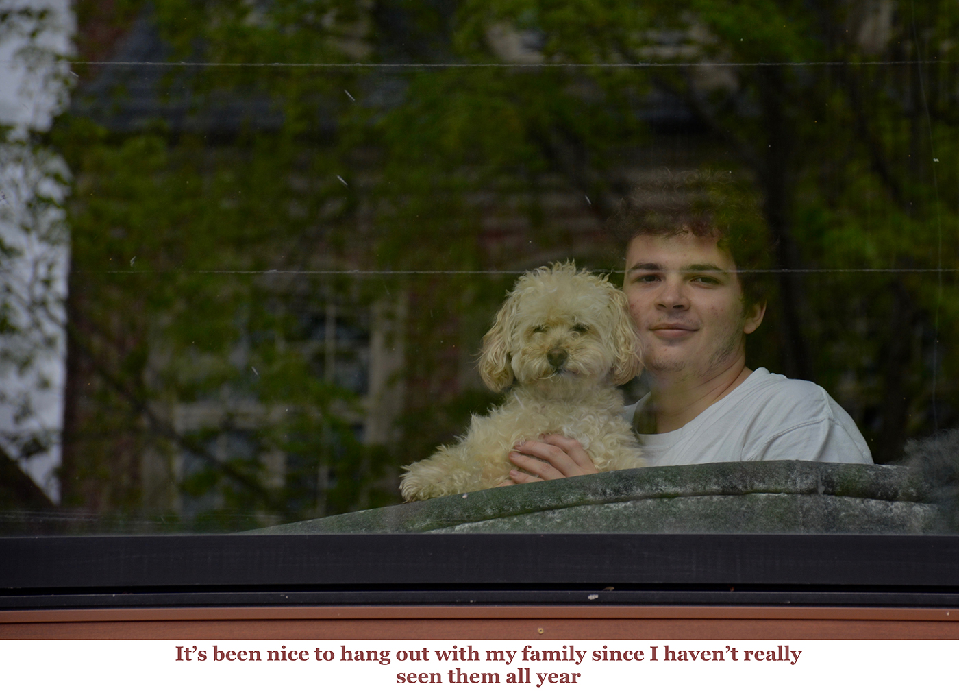 photo of person and dog at window