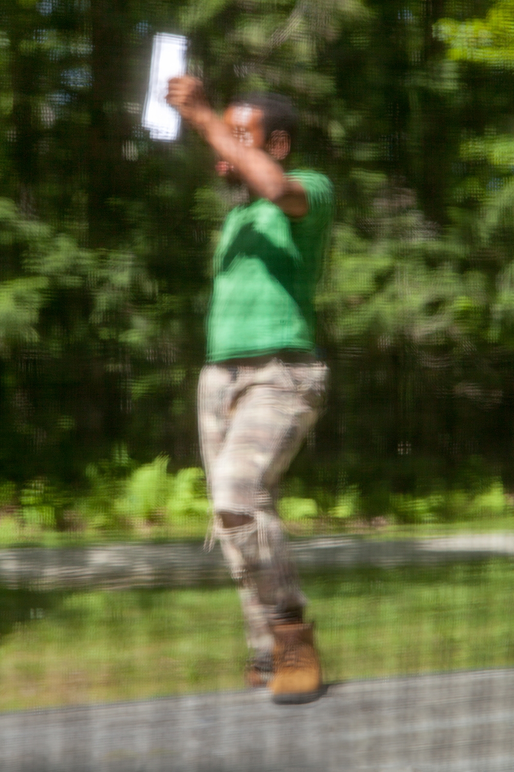 A blurred photograph of a man outdoors