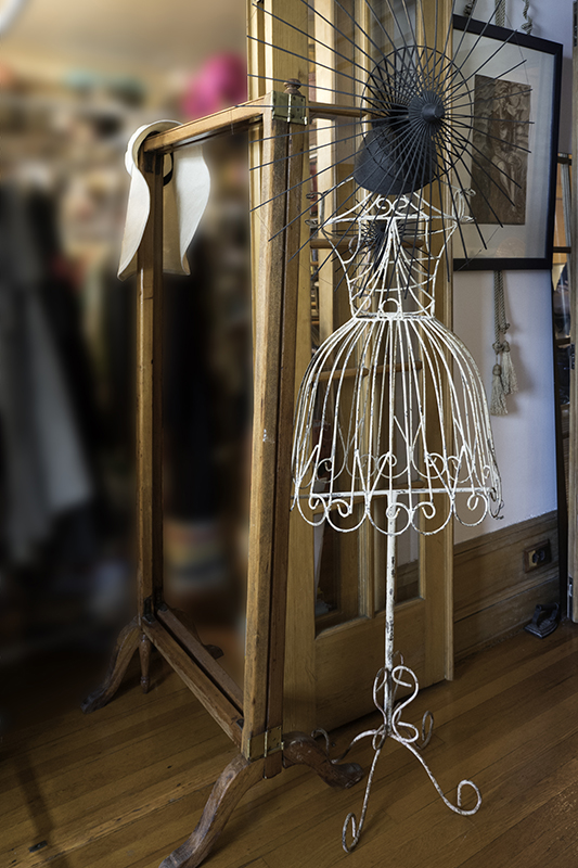 Photograph of wire dress mannequin in closet