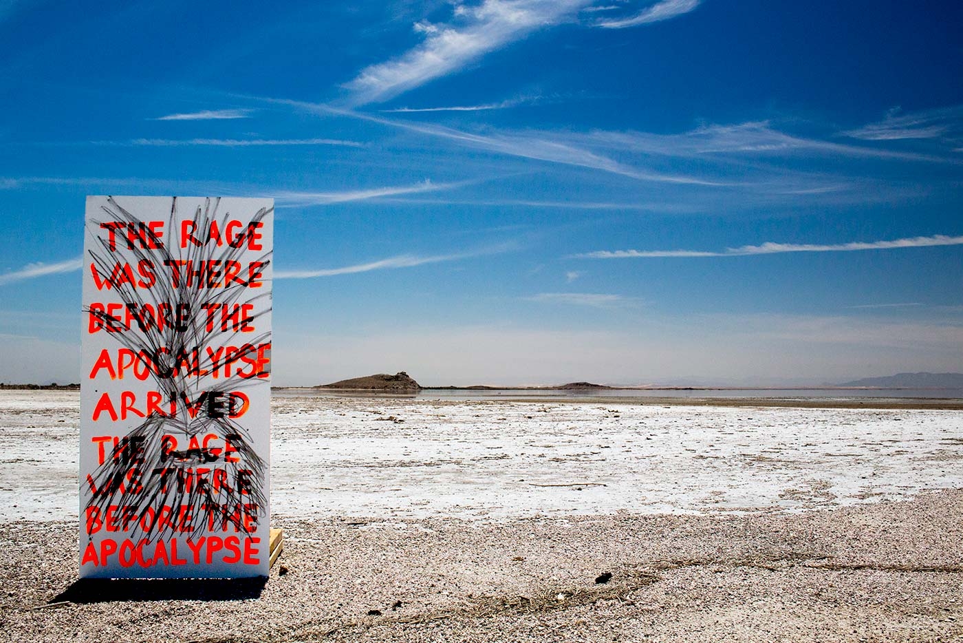 image by Caitlin Berrigan of a written sign in the middle of the desert