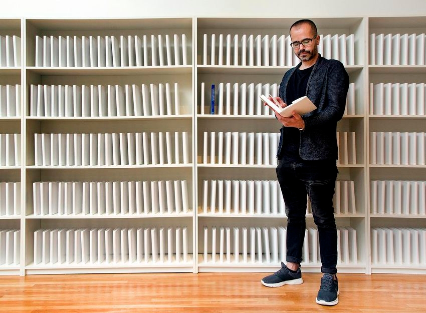 Iraqi-American artist Wafaa Bilal poses with his project 168:01 at the Aga Khan museum, July 17, 2018. Bilal's work is an open appeal to rebuild the Iraqi School of Fine Arts' library, book by book.  (ANDREW FRANCIS WALLACE / TORONTO STAR)
