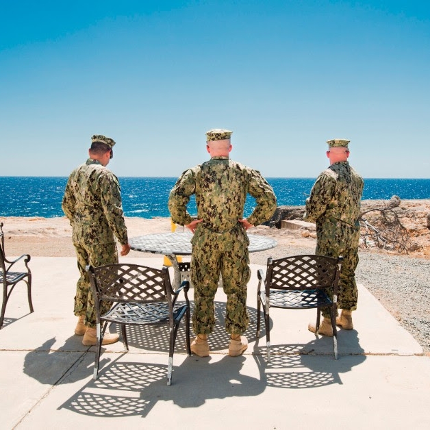 Photo of soldiers. Titled "Smoke Break", Camp America. From the Series Gitmo at Home, Gitmo at Play Welcome to Camp America project. By Debi Cornwall