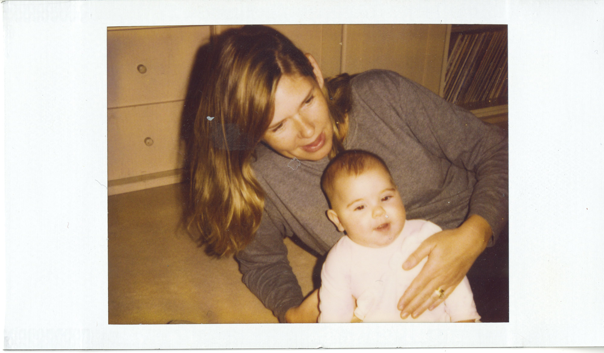 polaroid of woman and baby
