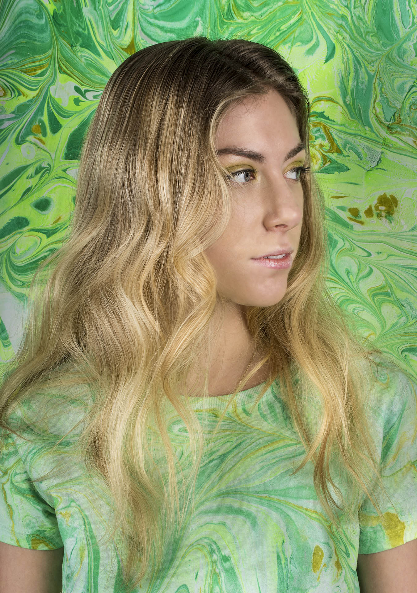 portrait of woman with green marbled background