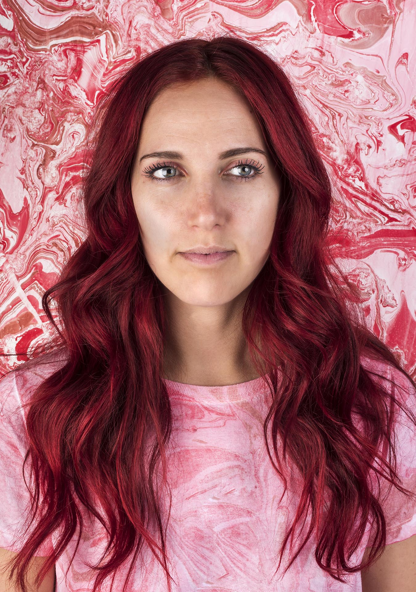 portrait of woman with red marbled background