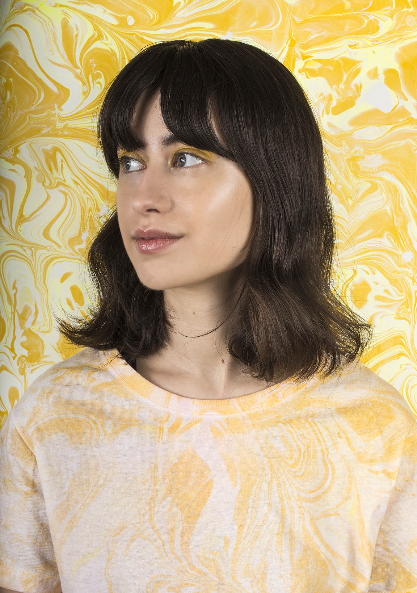 portrait of woman with yellow marbled background