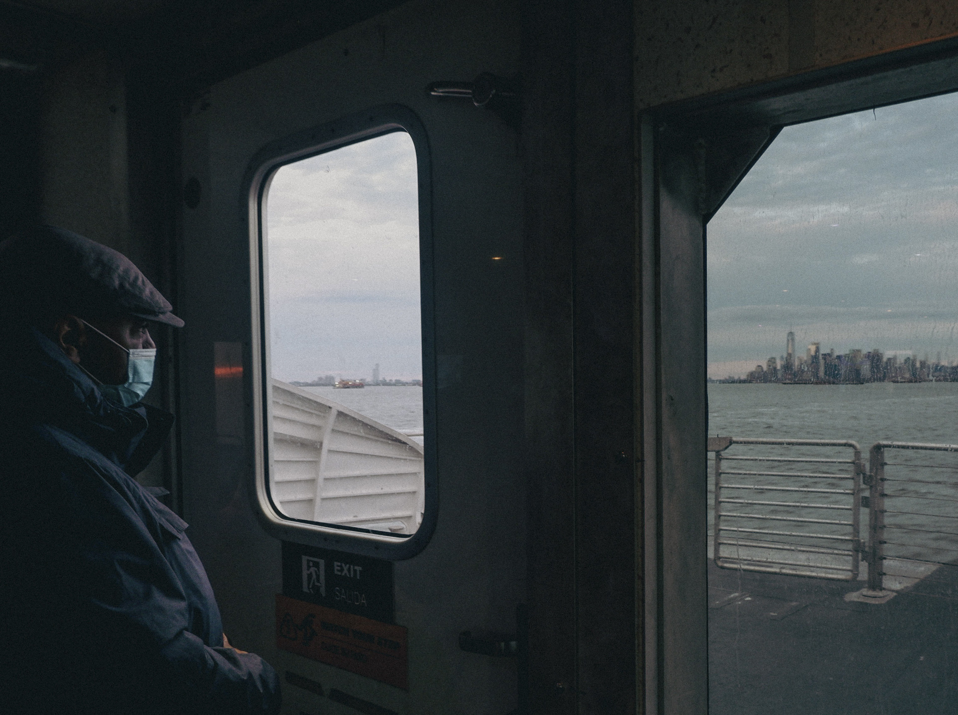 photo of a ferry with windows looking onto the NYC skyline