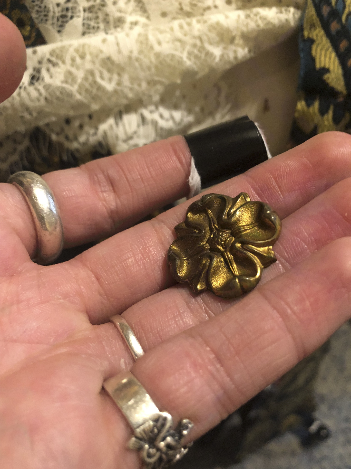 photo of a hand holding a gold cameo
