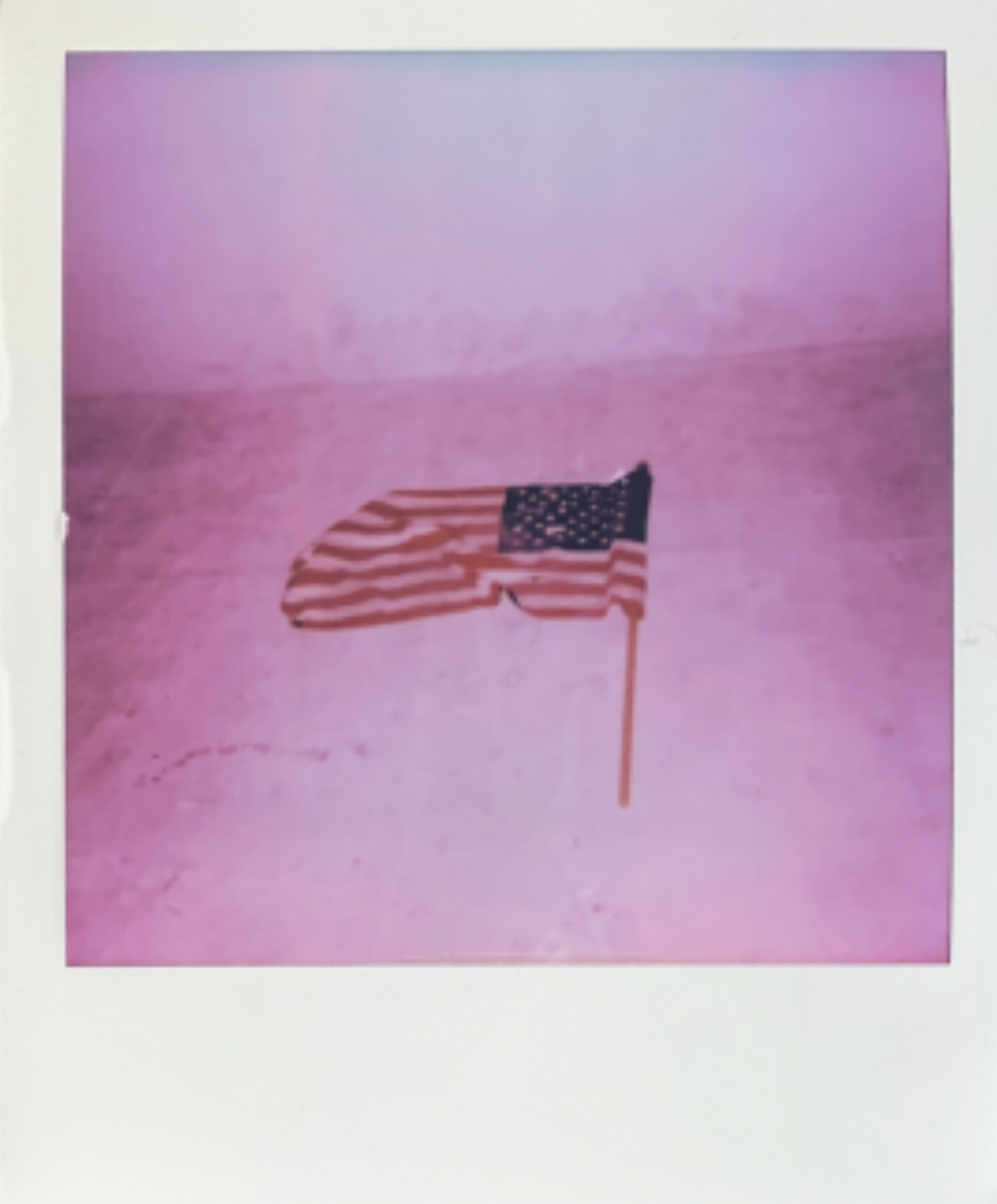 pink-tone photo of a us flag