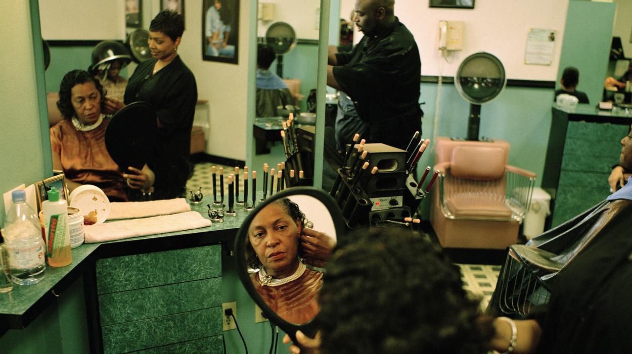 Woman through mirror in beauty shop