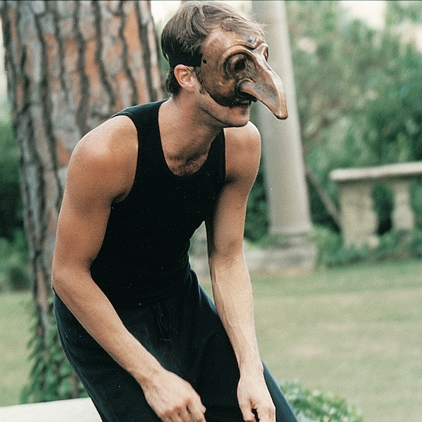 Male actor wearing a mask with long nose, outside in Florence, Italy.