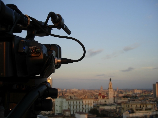 Camera in foreground, set up to shoot the city of Havana, Cuba at sunset.