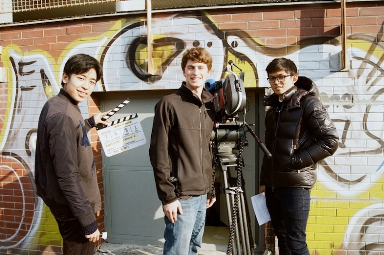 Film students on set with film equipment.