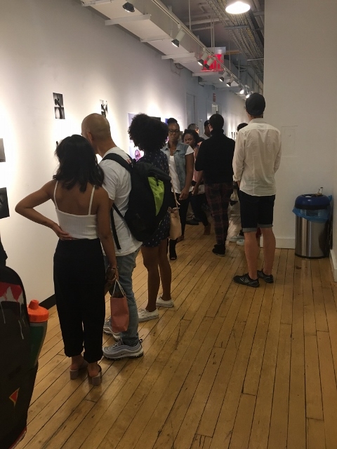 Students browsing the Photography & Imaging Final Gallery Exhibit.