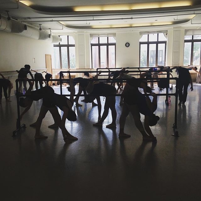 Dancers at the barre in a ballet studio class