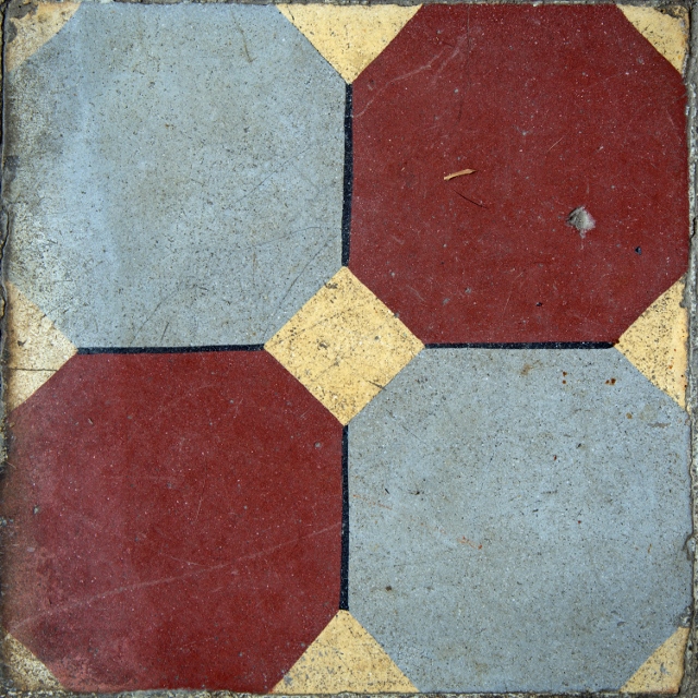 Red and blue octagonal ceramic tiles painted on a gold background.