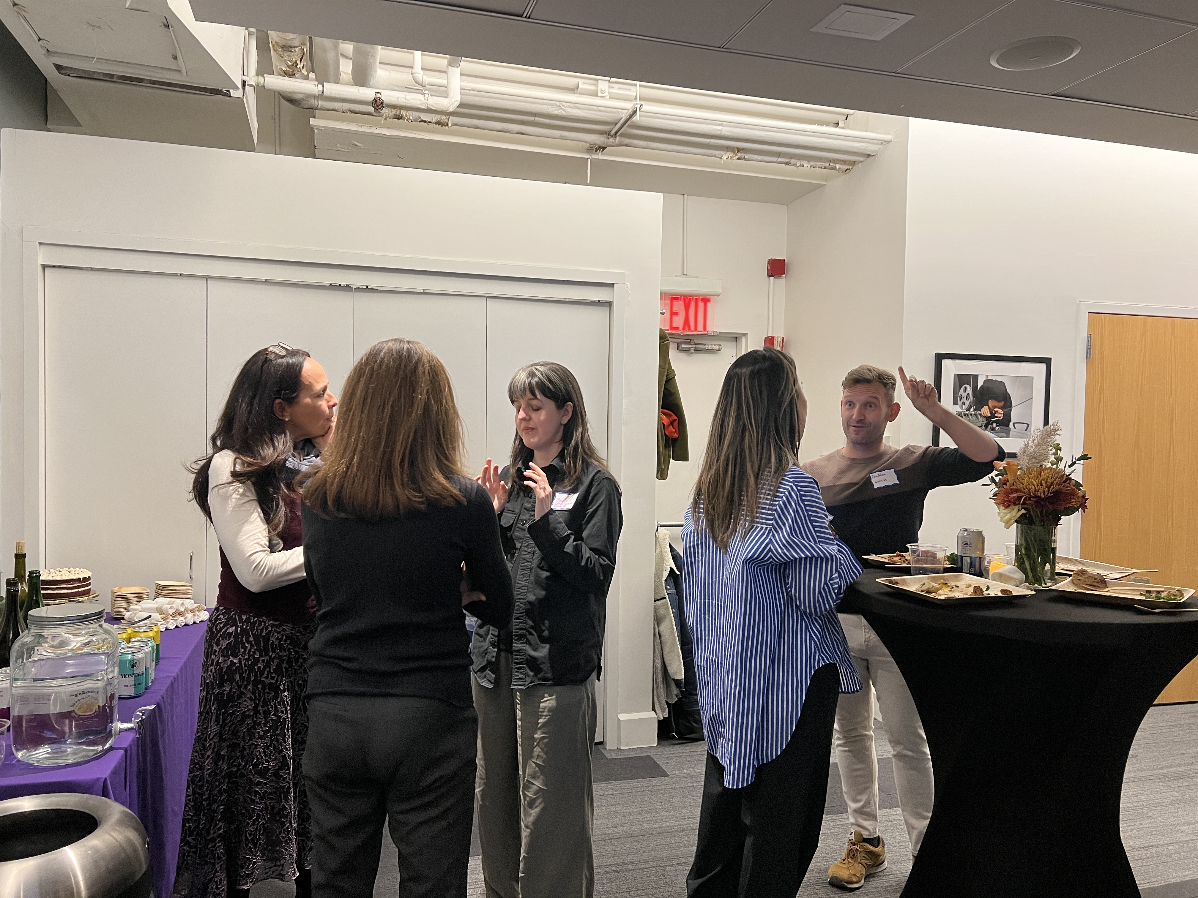 Tisch affiliated Catwalk Residency alumni gathered around tables.