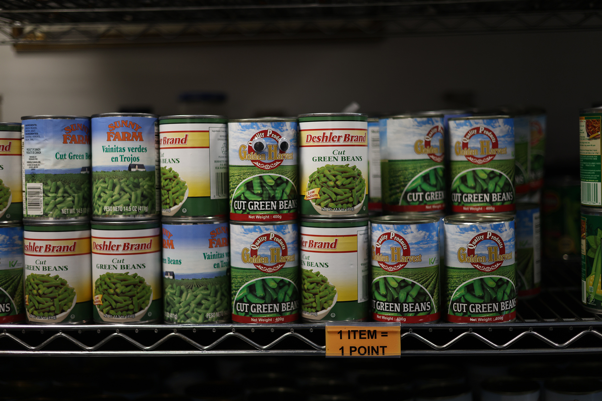 A shelf with cans of processed vegetables
