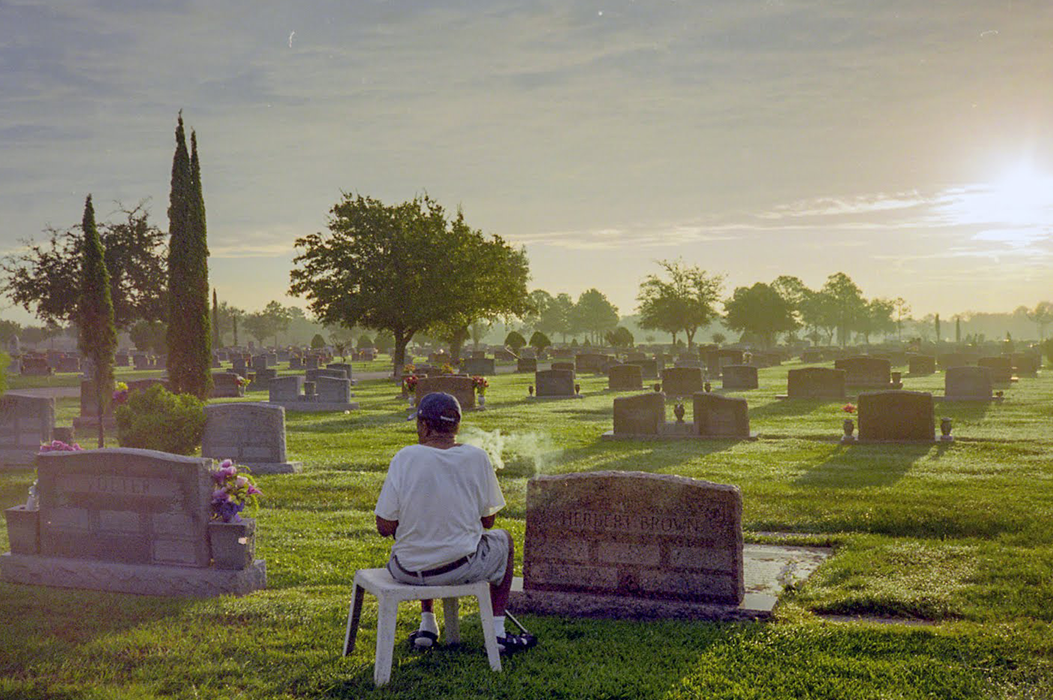 A man sitting in a cemetery
