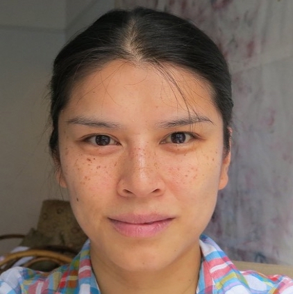 Headshot of Yue Yin wearing a plaid shirt