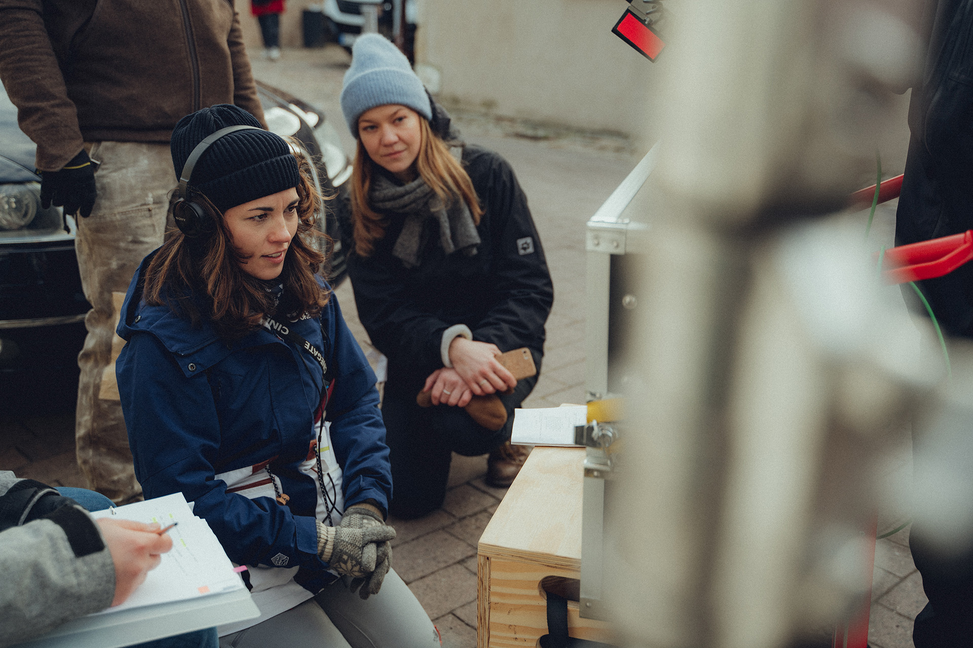 Two female filmmakers looking at a monitor on a film set